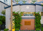 Thumbnail 44 of 85 - A modern building with a wooden entrance and a sign that reads "LEVEL".