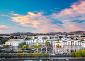 Thumbnail 2 of 72 - A cityscape with buildings and a mountain in the background.