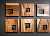 Thumbnail 18 of 72 - Six wooden frames with black silhouettes of people inside them.