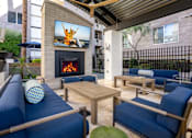 Thumbnail 40 of 72 - A patio with a fireplace and a television displaying a person jumping.