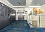 Thumbnail 23 of 72 - A hallway with a blue carpet and a white wall with a sign that says "hub".