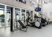 Thumbnail 14 of 72 - A gym with treadmills, elliptical machines, and other exercise equipment.