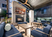 Thumbnail 39 of 72 - A patio with a fireplace and seating area.