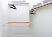 Thumbnail 64 of 72 - A white closet with a black hanger and a white door.