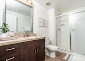 Thumbnail 67 of 72 - A bathroom with a toilet, sink, and mirror.