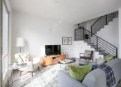 Thumbnail 4 of 19 - Staged Living Room with view of stairs