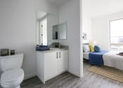 Thumbnail 10 of 19 - Bathroom with Staged Bedroom view
