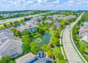 Thumbnail 43 of 49 - an aerial view of a neighborhood with a lake and fountain