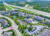 Thumbnail 48 of 49 - an aerial view of a neighborhood with houses and a swimming pool