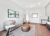 Thumbnail 17 of 49 - a living room with white walls and hardwood floors