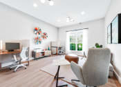 Thumbnail 14 of 49 - a living room with white walls and hardwood flooring