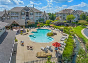 Thumbnail 47 of 49 - an aerial view of the resort style pool with lounge chairs and umbrellas
