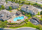 Thumbnail 42 of 49 - an aerial view of a resort style pool and community