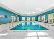 Thumbnail 25 of 49 - a swimming pool with blue walls and a skylight