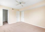 Thumbnail 22 of 24 - a bedroom with a ceiling fan and closet