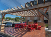 Thumbnail 19 of 19 - a patio with a table and chairs under a wooden roof