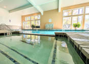 Thumbnail 21 of 26 - the indoor pool is heated and has large windows and a water feature