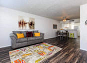 Thumbnail 16 of 42 - a living room and kitchen with a couch and a rug