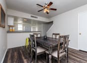 Thumbnail 15 of 42 - a dining room with a table and chairs and a ceiling fan