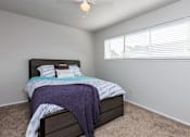 Thumbnail 18 of 42 - a bedroom with a bed and a large window