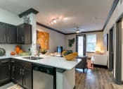Thumbnail 44 of 54 - the view of a kitchen and living room with a couch and a sink
