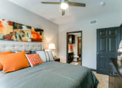 Thumbnail 37 of 54 - a bedroom with a bed and a ceiling fan