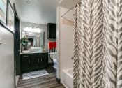 Thumbnail 41 of 54 - a bathroom with a shower curtain and a toilet and sink