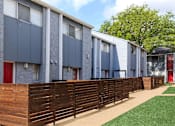 Thumbnail 27 of 42 - a row of houses with a wooden fence in front of them