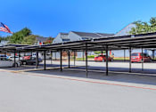 Thumbnail 20 of 42 - a covered parking lot with cars in a parking lot