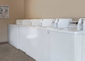 Thumbnail 9 of 42 - a row of white washing machines in a room