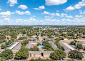 Thumbnail 1 of 17 - an aerial view of a city with houses and trees