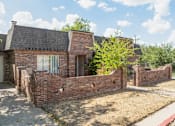 Thumbnail 15 of 17 - the front of a brick house with a brick wall