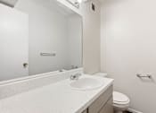 Thumbnail 9 of 17 - a bathroom with a sink and a toilet and a mirror