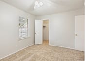 Thumbnail 13 of 17 - an empty bedroom with a closet and a window