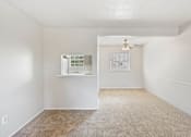 Thumbnail 12 of 17 - a living room with white walls and flooring and a ceiling fan