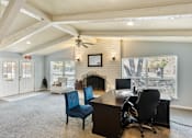 Thumbnail 6 of 17 - a leasing office with a desk and chairs and a fireplace