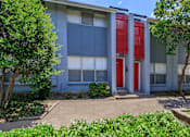 Thumbnail 24 of 42 - the front of a building with a red door