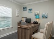 Thumbnail 11 of 42 - a office with a desk and a chair and a window