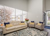 Thumbnail 14 of 42 - a living room with a couch and two chairs and a rug