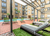Thumbnail 5 of 34 - A patio area with sun loungers and a pool.
