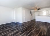 Thumbnail 29 of 42 - a living room with a hard wood floor and a ceiling fan