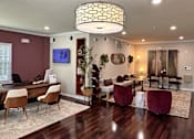 Thumbnail 5 of 26 - A modern living room with a dark wood floor and a large chandelier.