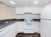 Thumbnail 36 of 42 - a kitchen with white cabinets and a stove and a sink