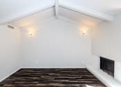 Thumbnail 32 of 42 - a living room with a fireplace and white walls