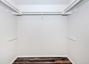 Thumbnail 35 of 42 - an empty room with white walls and a wood floor