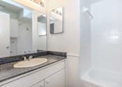 Thumbnail 41 of 42 - a bathroom with a sink and a shower and a mirror