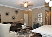 Thumbnail 32 of 40 - Interior room with white chair and brown couch