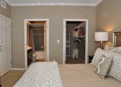 Thumbnail 38 of 40 - a bedroom with a bed and a closet and a bathroom