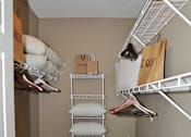 Thumbnail 39 of 40 - a walk in closet with a rack for clothes and a pile of pillows