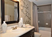 Thumbnail 40 of 40 - a bathroom with a sink and a mirror and a shower